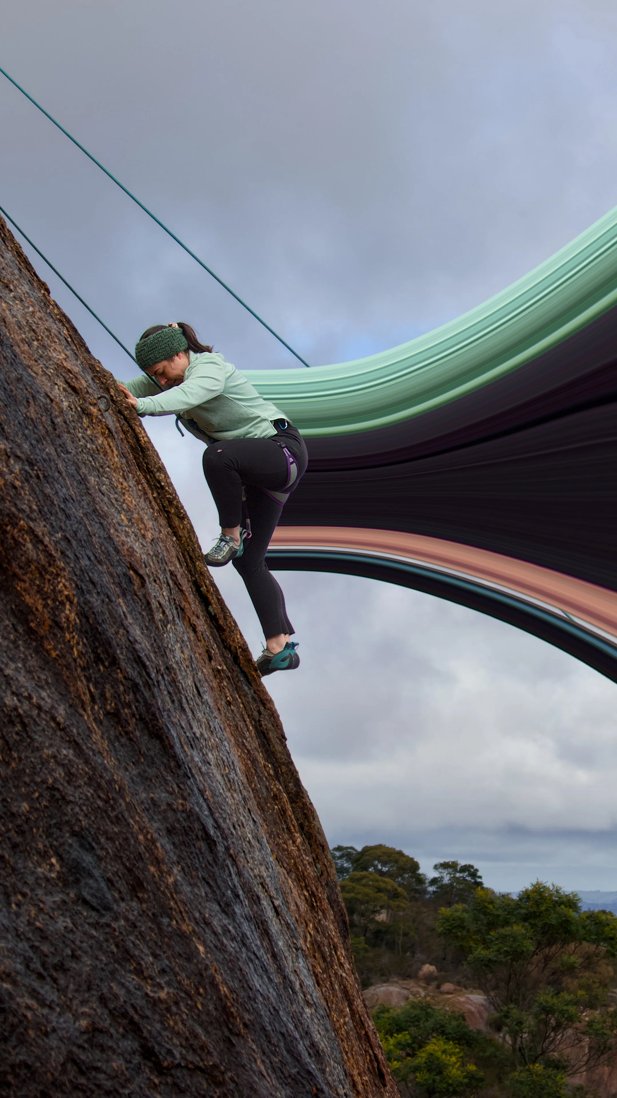 A climber in a pale green top on dark rock, with sweeping bands of colour extending behind them.